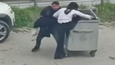 Alkollü olduğu iddia edilen kadın, gündüz vakti yol kenarında önce çöp konteynırına girmeye çalıştı sonra kendini yere attı