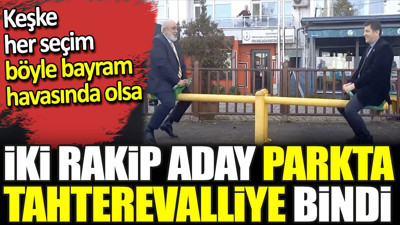 İki rakip aday parkta tahterevalliye bindi. Keşke her seçim böyle bayram havasında olsa