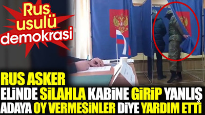 Rus asker elinde silahla kabine girip yanlış adaya oy vermesinler diye yardım etti . Rus usulü demokrasi