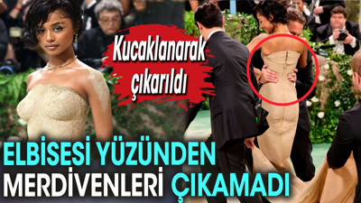 Elbisesi yüzünden merdivenleri çıkamadı. Kucaklanarak çıkarıldı