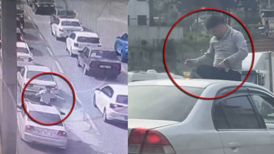 Hatay’da trafikte tehlikeli hareket! Otomobilin tavanında içki içti kameraya yansıdı