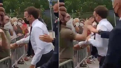 Sol eliyle Macron'un bir elini tuttu sağ elinin içiyle şırrak diye tokatı yerleştirdi