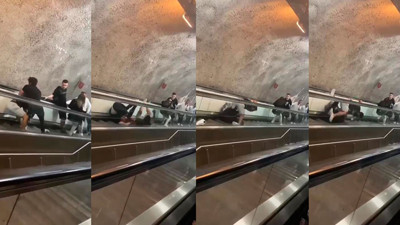 Yürüyen merdivenlerde yuvarlanarak kavga ettiler
