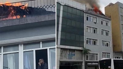 Günün fotoğrafı geldi. Yanan binanın penceresinden olup biteni böyle izledi