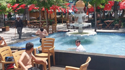 Havalardan bunalan çocuklar süs havuzuna girdi